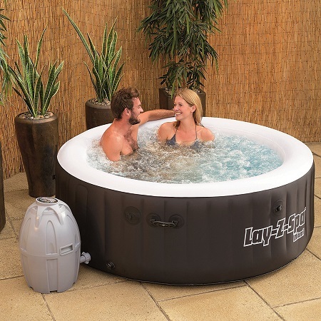 SaluSpa Miami AirJet inflatable hot tub with people.